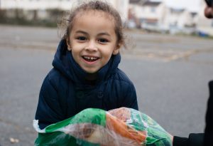3-year-old Ian holds a turkey his mother received from a holiday food distribution in Philadelphia.